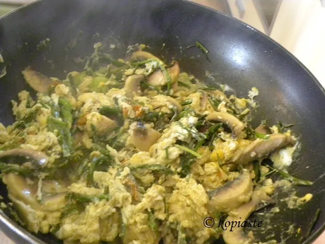 Scrambled eggs with wild asparagus courgette flowers and mushrooms